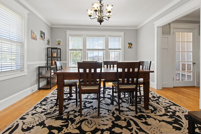 797 Main St, South Portland, ME 04106 - dining room with a chandelier, light wood-style floors, ornamental molding, and baseboards