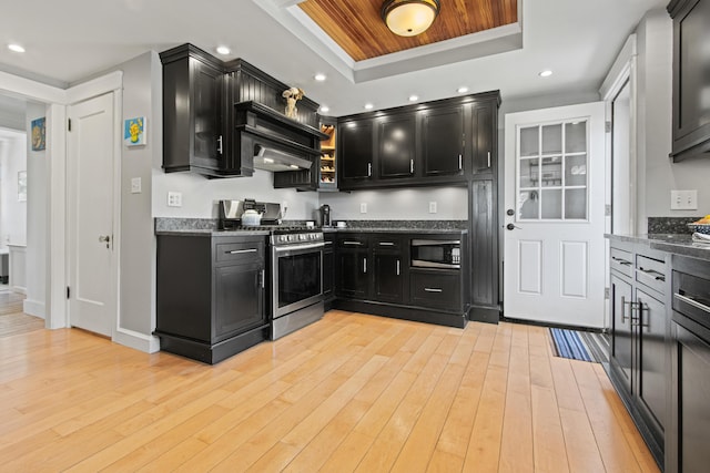 797 Main St, South Portland, ME 04106 - kitchen with appliances with stainless steel finishes, dark cabinets, a raised ceiling, light wood-style flooring, and recessed lighting