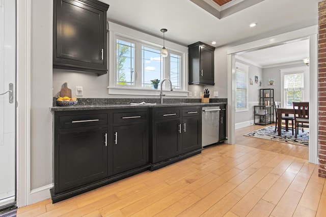 797 Main St, South Portland, ME 04106 - kitchen with dark cabinetry, stainless steel dishwasher, crown molding, light wood-type flooring, and dark stone counters
