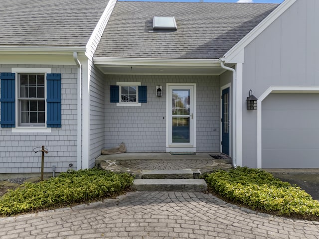 14 Merriconeag Ln, Harpswell, ME 04079 - doorway to property with a garage, roof with shingles, and a porch