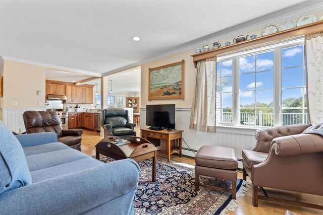 14 Merriconeag Ln, Harpswell, ME 04079 - living area featuring a wainscoted wall, crown molding, light wood finished floors, and a baseboard heating unit