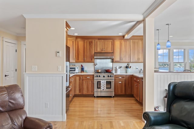 14 Merriconeag Ln, Harpswell, ME 04079 - kitchen with high end stainless steel range oven, open floor plan, under cabinet range hood, light countertops, and crown molding