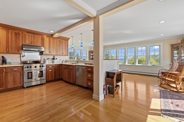 14 Merriconeag Ln, Harpswell, ME 04079 - kitchen with stainless steel appliances, a sink, under cabinet range hood, brown cabinets, and ornamental molding