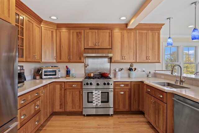 14 Merriconeag Ln, Harpswell, ME 04079 - kitchen with stainless steel appliances, a sink, light countertops, under cabinet range hood, and ornamental molding