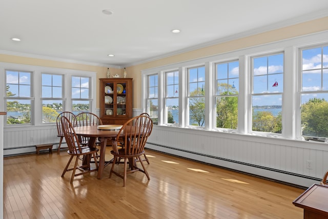 14 Merriconeag Ln, Harpswell, ME 04079 - dining room with a baseboard radiator, healthy amount of natural light, light wood finished floors, crown molding, and wainscoting