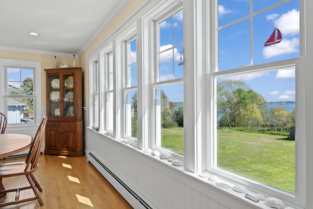 14 Merriconeag Ln, Harpswell, ME 04079 - dining room featuring crown molding, healthy amount of natural light, light wood-style flooring, and a wainscoted wall