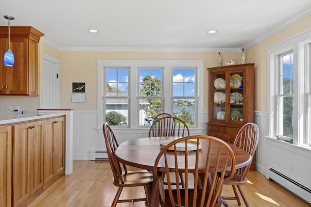14 Merriconeag Ln, Harpswell, ME 04079 - dining room featuring a baseboard heating unit, light wood-style flooring, wainscoting, ornamental molding, and a decorative wall