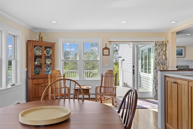 14 Merriconeag Ln, Harpswell, ME 04079 - dining room featuring wainscoting, wood finished floors, crown molding, and a decorative wall