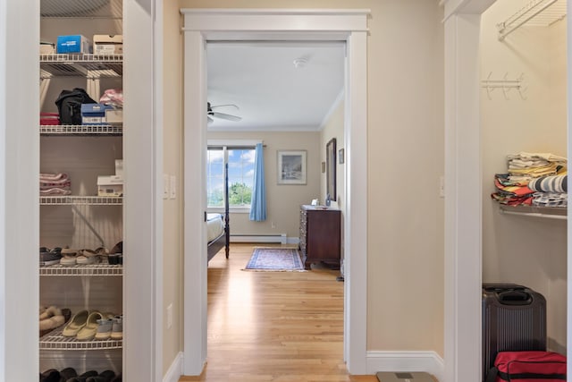 14 Merriconeag Ln, Harpswell, ME 04079 - hallway with light wood-style floors, baseboard heating, baseboards, and crown molding