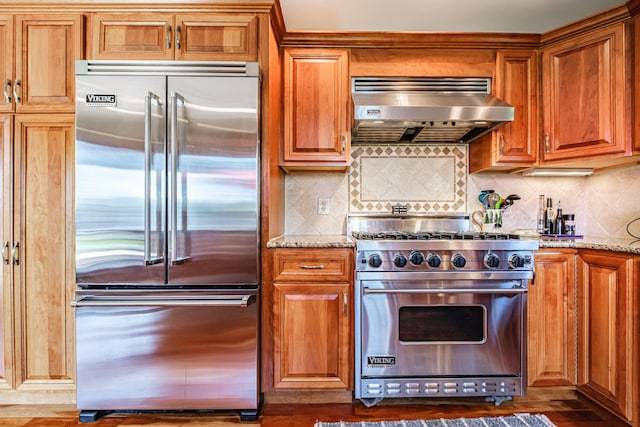 147 Sand Bar Rd, Windham, ME 04062 - kitchen featuring high end appliances, exhaust hood, brown cabinetry, and light stone counters