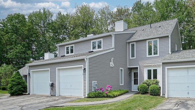 17 Cammock Rd Unit 17, Scarborough, ME 04074 - view of front of property with a chimney, roof with shingles, a garage, and asphalt driveway