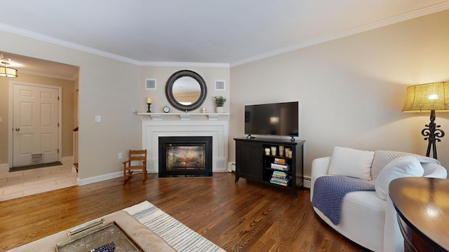 17 Cammock Rd Unit 17, Scarborough, ME 04074 - living area with wood finished floors, ornamental molding, a baseboard radiator, a fireplace with flush hearth, and baseboards
