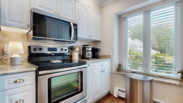 17 Cammock Rd Unit 17, Scarborough, ME 04074 - kitchen featuring stainless steel appliances, crown molding, a baseboard radiator, decorative backsplash, and white cabinetry