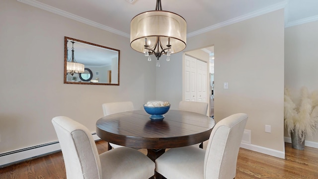 17 Cammock Rd Unit 17, Scarborough, ME 04074 - dining area with a chandelier, a baseboard heating unit, wood finished floors, crown molding, and baseboards