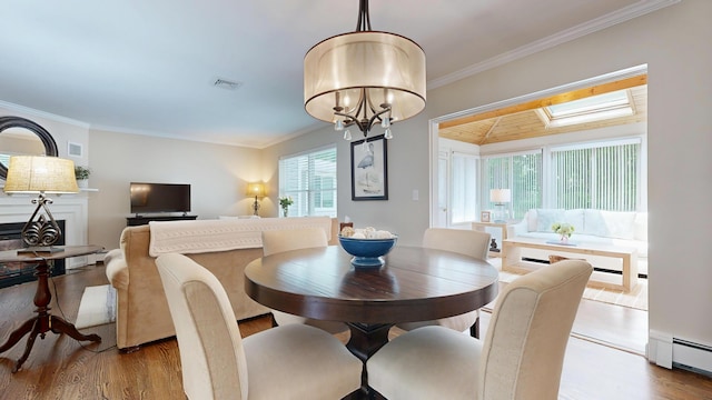 17 Cammock Rd Unit 17, Scarborough, ME 04074 - dining space featuring a baseboard radiator, wood finished floors, ornamental molding, and a chandelier