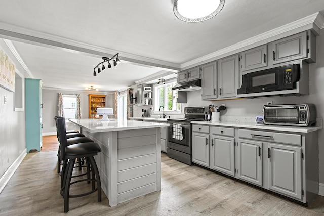 463 Brook St, Westbrook, ME 04092 - kitchen with gray cabinets, stainless steel range with electric cooktop, black microwave, a kitchen island, and crown molding