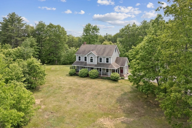 26 Serenity Ln, Topsham, ME 04086 - view of front of property with a porch, a front lawn, a chimney, a view of trees, and a shingled roof