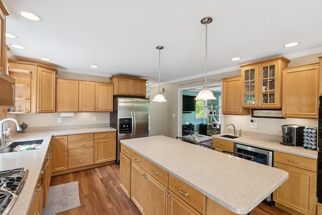 26 Serenity Ln, Topsham, ME 04086 - kitchen featuring stainless steel appliances, crown molding, a center island, wood finished floors, and a sink