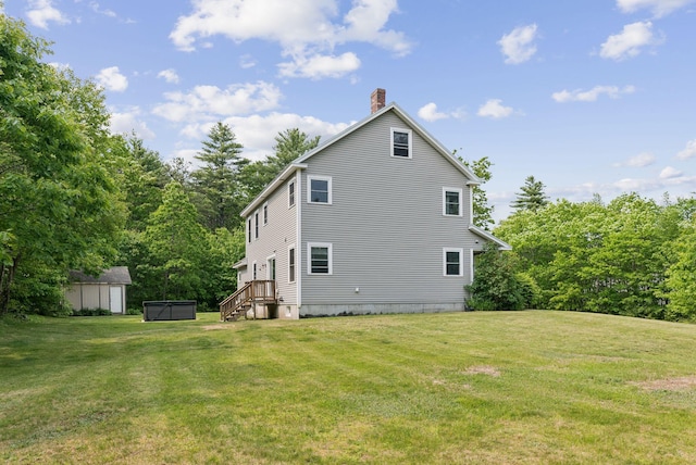 26 Serenity Ln, Topsham, ME 04086 - rear view of property with a chimney and a lawn