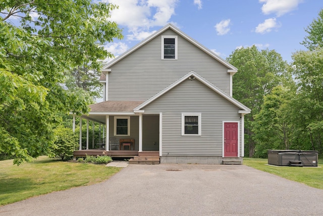 26 Serenity Ln, Topsham, ME 04086 - view of front of property featuring a hot tub, a front lawn, and a porch
