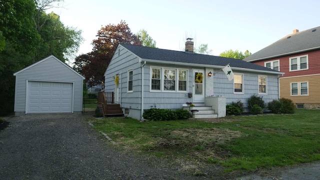 23 Rudman Rd, Portland, ME 04102 - view of front of home with an outbuilding, a chimney, a detached garage, driveway, and a front yard