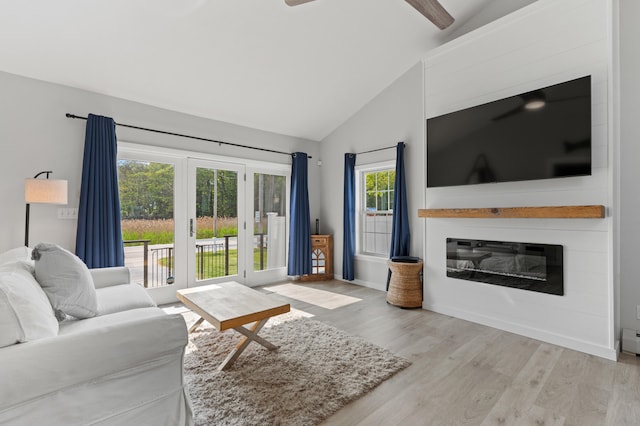 27 Seaside Ave, Saco, ME 04072 - living room with wood finished floors, a glass covered fireplace, ceiling fan, french doors, and high vaulted ceiling