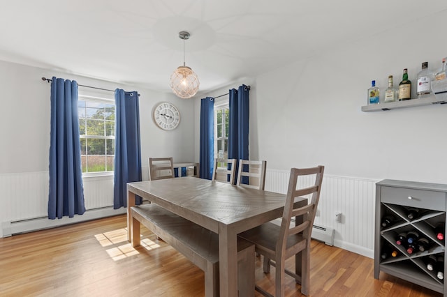 27 Seaside Ave, Saco, ME 04072 - dining area with a baseboard heating unit, wainscoting, plenty of natural light, and light wood-style floors