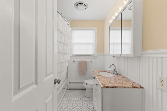 27 Seaside Ave, Saco, ME 04072 - bathroom with a baseboard heating unit, wainscoting, vanity, and curtained shower