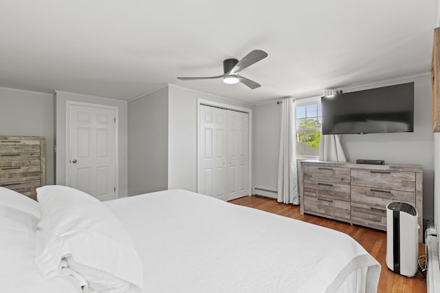 27 Seaside Ave, Saco, ME 04072 - bedroom featuring wood finished floors, ornamental molding, a ceiling fan, a baseboard radiator, and a closet