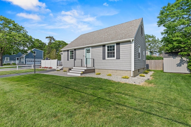 27 Seaside Ave, Saco, ME 04072 - view of front of property with a garage, roof with shingles, and a storage unit