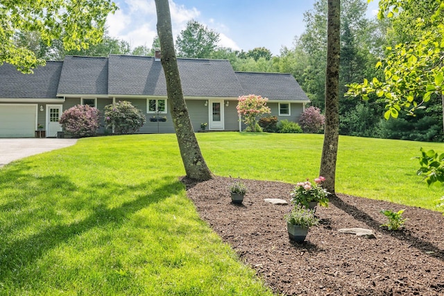 60 Evergreen Dr, Hermon, ME 04401 - view of front of property with a front yard, concrete driveway, a garage, and a shingled roof