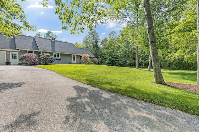 60 Evergreen Dr, Hermon, ME 04401 - view of front of home with driveway, a front lawn, a garage, and a chimney