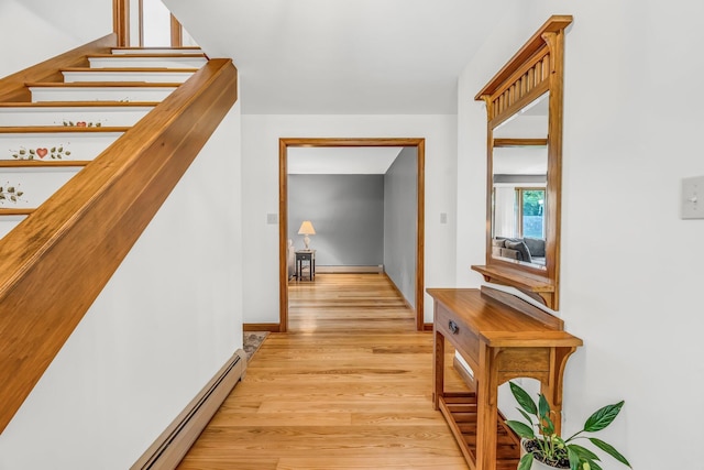 60 Evergreen Dr, Hermon, ME 04401 - hall featuring light wood-type flooring, a baseboard radiator, a baseboard heating unit, and stairs