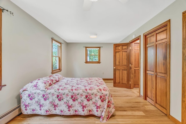 60 Evergreen Dr, Hermon, ME 04401 - bedroom featuring a baseboard radiator, light wood-style floors, ceiling fan, and a closet