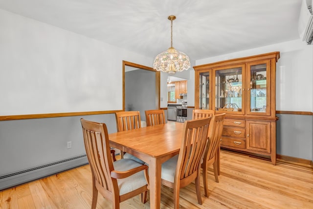 60 Evergreen Dr, Hermon, ME 04401 - dining space featuring a chandelier, baseboard heating, light wood finished floors, and a wall unit AC