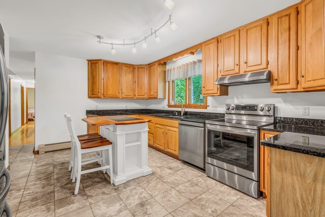 60 Evergreen Dr, Hermon, ME 04401 - kitchen featuring stainless steel appliances, under cabinet range hood, a baseboard heating unit, and dark stone counters