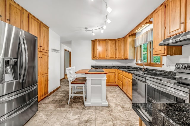 60 Evergreen Dr, Hermon, ME 04401 - kitchen featuring appliances with stainless steel finishes, under cabinet range hood, a center island, and brown cabinets