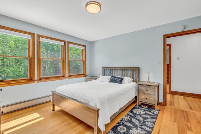 60 Evergreen Dr, Hermon, ME 04401 - bedroom featuring a baseboard heating unit and light wood-type flooring