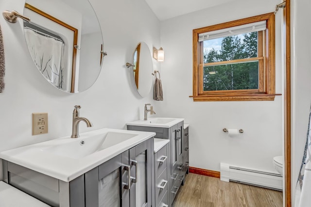 60 Evergreen Dr, Hermon, ME 04401 - bathroom with a baseboard radiator, two vanities, and wood finished floors