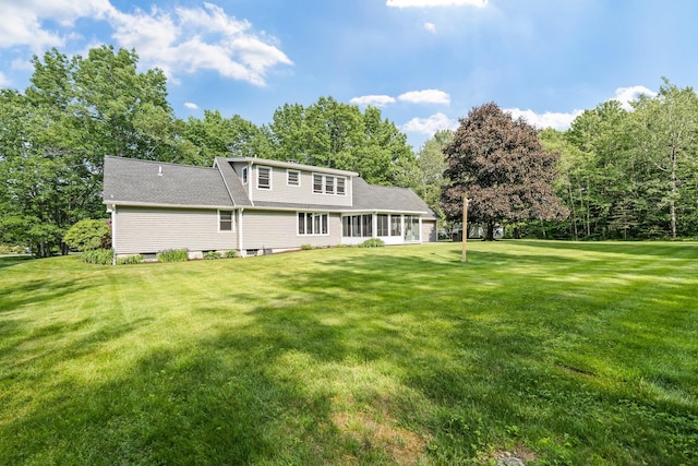 60 Evergreen Dr, Hermon, ME 04401 - back of property with a lawn and view of wooded area