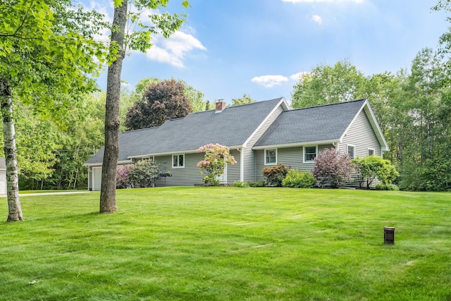 60 Evergreen Dr, Hermon, ME 04401 - view of front of house with a front yard, a chimney, a garage, and a shingled roof