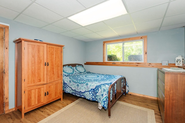 77 Toothaker Pond Rd, Phillips, ME 04966 - bedroom featuring a drop ceiling, light wood finished floors, and baseboards