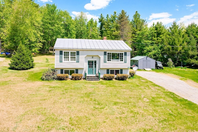 77 Toothaker Pond Rd, Phillips, ME 04966 - split foyer home featuring a front yard, a chimney, and driveway