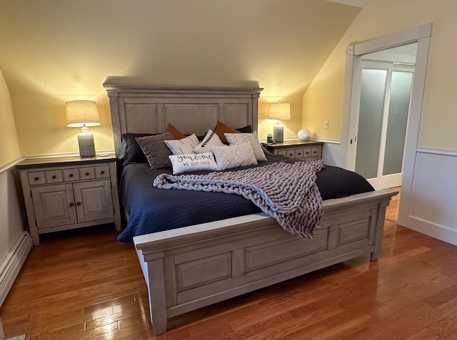 46 3rd St, Presque Isle, ME 04769 - bedroom with a baseboard radiator, wood finished floors, and lofted ceiling