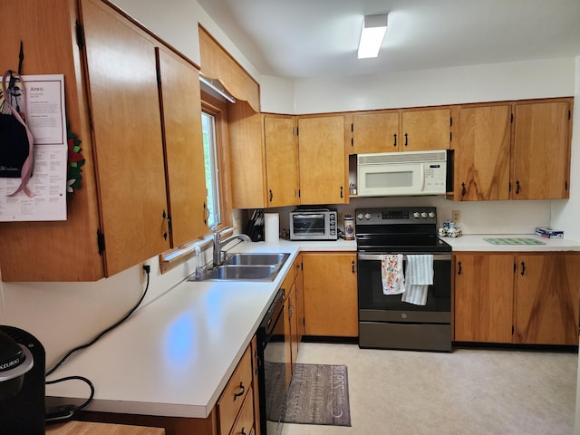 18 Oak St, Jay, ME 04239 - kitchen featuring black appliances, a sink, light countertops, and brown cabinetry