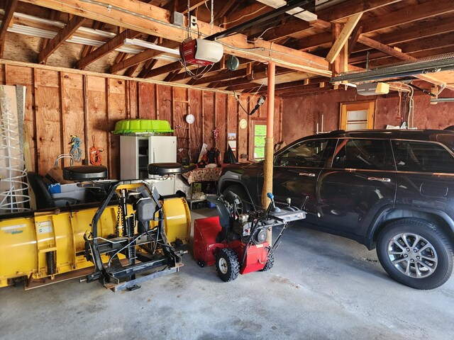18 Oak St, Jay, ME 04239 - garage featuring a garage door opener
