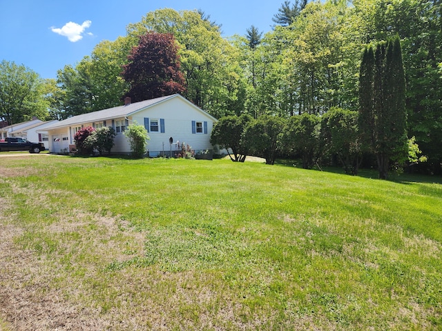 18 Oak St, Jay, ME 04239 - view of grassy yard with a garage