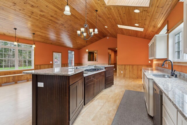 20 Motorcycle Dr, Windham, ME 04062 - kitchen featuring a sink, wainscoting, wooden walls, vaulted ceiling, and a skylight
