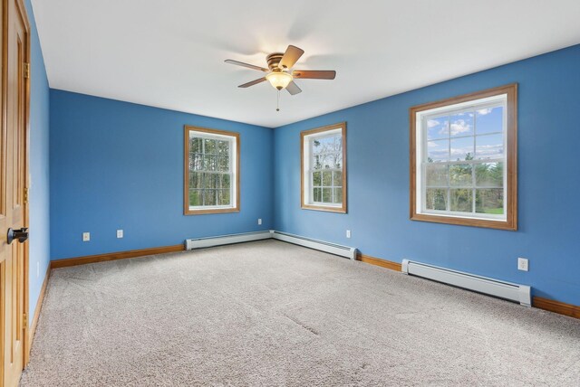 20 Motorcycle Dr, Windham, ME 04062 - spare room featuring a baseboard heating unit, ceiling fan, plenty of natural light, and carpet flooring