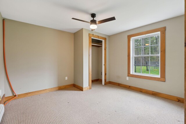 20 Motorcycle Dr, Windham, ME 04062 - unfurnished bedroom featuring baseboards, carpet, a closet, and ceiling fan